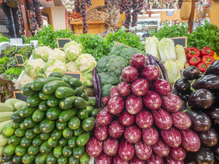 several types of vegetables on the shelf of a fruit store