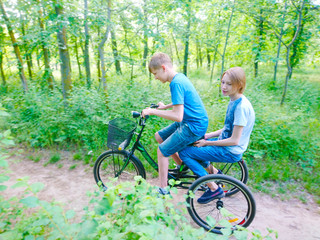 Two guys ride a tricycle