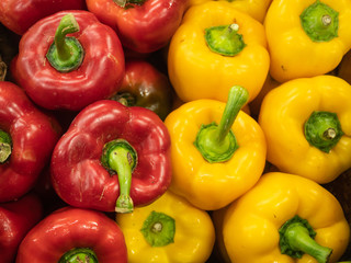 view of several types of peppers on the shelves of a fruit shop
