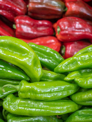 view of several types of peppers on the shelves of a fruit shop