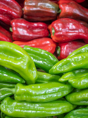 view of several types of peppers on the shelves of a fruit shop
