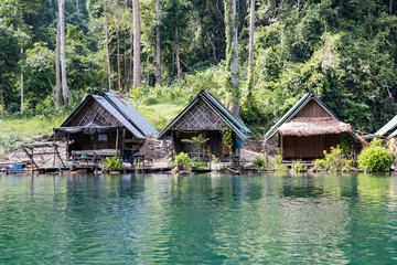 Fototapeta premium Tropical lakeside hut in ratchaprapa dam or Cheow Lan Dam Suratthani, Thailand.