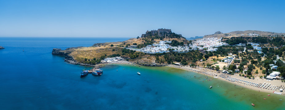  Aerial birds eye view drone photo of village Lindos, Rhodes island, Greece. Beautiful panorama with castle, Mediterranean sea coast. Famous tourist destination in South Europe. © raland