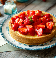 Homemade delicious strawberry tart or pie with sweet berries on top