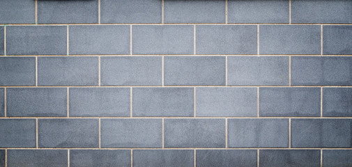High resolution full frame background of a new, modern and clean wall or building exterior made of light bluish gray stone slabs. Vignetting and copy space.