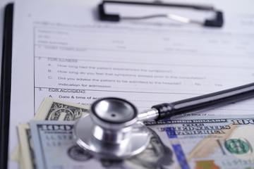 Health insurance accident claim form with stethoscope and US dollar banknotes, Medical concept.         