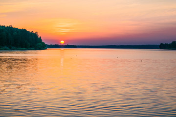 Sunrises sunsets on a summer pond in the forest