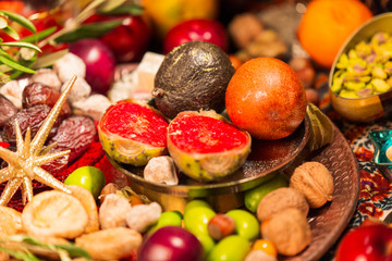Fototapeta na wymiar Close Up of Table decorated with Autumn and Winter Fruits and Edibles