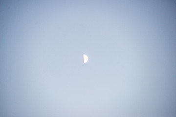 moon rising on dark blue sky