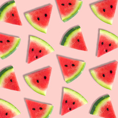 Colorful summer fruit pattern of watermelon slices on a soft pink background