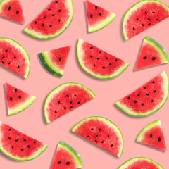 Colorful summer fruit pattern of watermelon slices on a pastel pink background