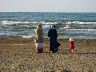 Muslim women hijab walking beach. Muslim women in hijab walking On the beach of the Caspian Sea in Iran, Anzali.