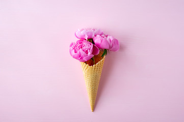 Peony flowers in the waffle cone. Creative design.