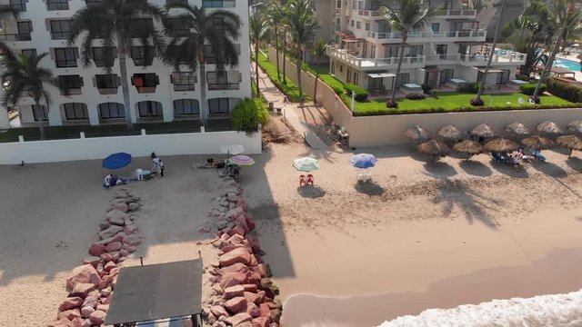 Aerial footage of the beautiful beach and hotels of Puerto Vallarta in Mexico, the town is on the Pacific coast in the state known as Jalisco showing the mountains in the background