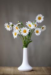 bouquet of flowers in vase on white background