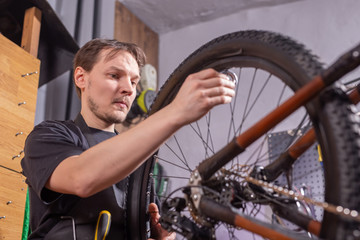 Fototapeta na wymiar A man mechanic repairing the bicycle in his service