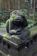 Fototapeta na wymiar Statue of monkey at Ubud Monkey Forest sanctuary at Bali, Indonesia