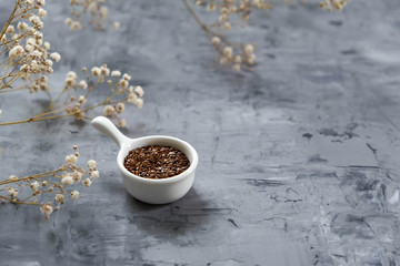 Flax seeds on a gray concrete background. Healthy food, vegetarian. Diet