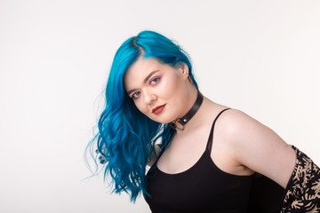 Fototapeta premium People and fashion concept - Beautiful woman with blue hair posing over white background