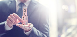 Hand change wooden cubes with New year 2019 to 2020 concept.
