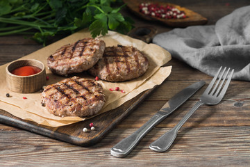 Grilled cutlets on a wooden Board on a wooden table. Rustic style