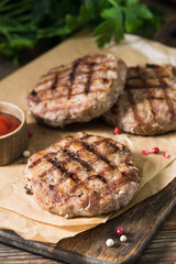 Grilled cutlets on a wooden Board on a wooden table. Rustic style