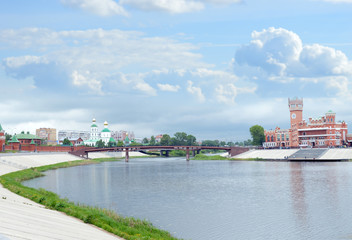 Fototapeta premium city street with a bridge over the river temples and churches on a summer day