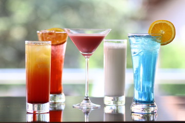 lots of different tropical cocktails on the bar table