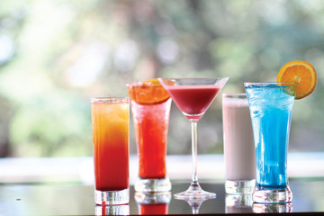 lots of different tropical cocktails on the bar table