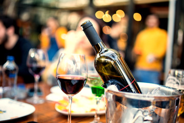 red wine on open air restaurant cafe romantic joyful young adults table