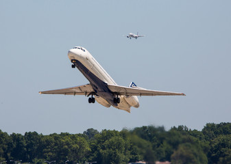 Two commercial airliners in flight in clear blue sky