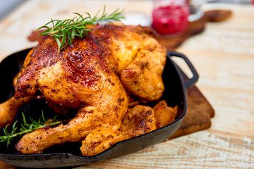 Baked whole chicken with apples in pan