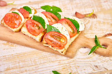 Bruschetta with tomatoes, mozzarella cheese and basil