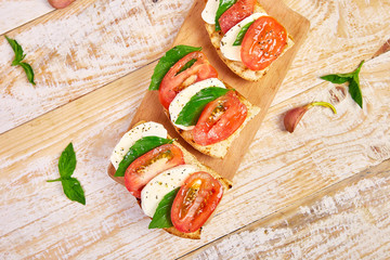 Bruschetta with tomatoes, mozzarella cheese and basil
