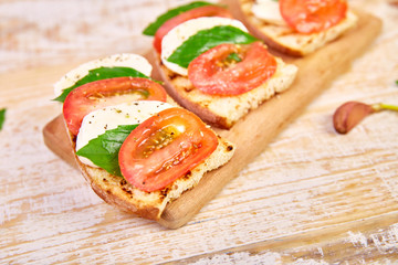 Bruschetta with tomatoes, mozzarella cheese and basil