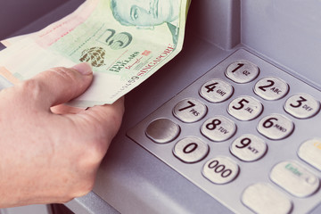Singapore dollars withdrawn from an ATM