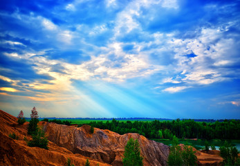 Dramatic light beams illuminating awesome sand hills landscape