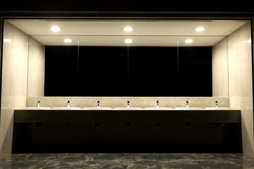 Public toilet and bathroom interior with wash basin..Faucets with of washbasins in public toilet...