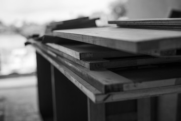 Selective focus on monochrome pile of wooden boards for installing the interior work at the construction site
