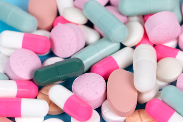 Obraz na płótnie Canvas Heap of colourful pills and capsules on a table