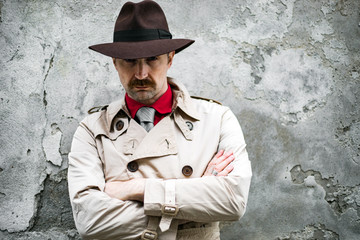 Portrait of a detective with folded arms in a ghetto