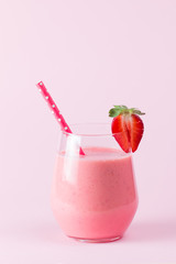 A glass of fresh strawberry smoothie on a wooden background. Summer drink shake, milkshake, juice and refreshment organic concept.