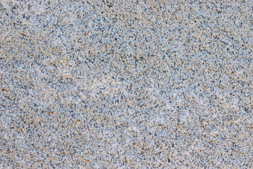 Texture natural smooth stone. Background natural stone with splashes of different colors. Rusty spots.