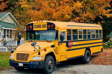 Fototapeta na wymiar School bus on driveway at autumn, Maine, USA.