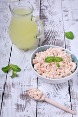 Cottage cheese of baked milk against the white wooden background