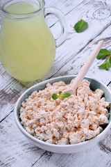 Cottage cheese of baked milk against the white wooden background