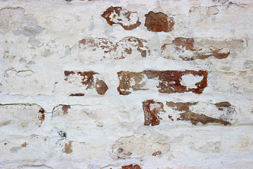 Peeled off with time, white painted brickwork 