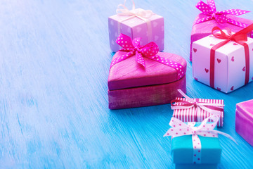 Various Valentine’s day gift boxes over blue wooden background
