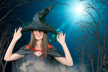  woman model in witch halloween costume over halloween background