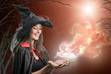  woman model in witch halloween costume over halloween background